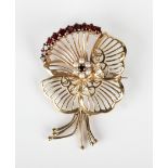 A 9ct gold, garnet and cultured pearl brooch, designed as a stylized pansy, London 1958, weight 7.