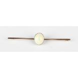 A gold and opal single stone bar brooch, claw set with an oval opal, unmarked, weight 5.2g, width