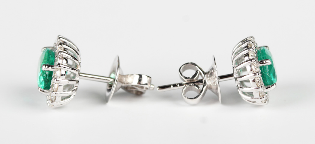 A pair of white gold, emerald and diamond oval cluster earstuds, each claw set with the oval cut - Image 2 of 2