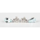 A pair of white gold, aquamarine and diamond pendant earrings, each stylized tied ribbon bow