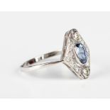 A platinum, sapphire and diamond ring in a lozenge shaped design, collet set with the oval cut