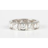A platinum and diamond full eternity ring, mounted with thirteen circular cut diamonds in square