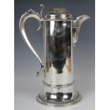A George IV large silver flagon with reeded domed hinged lid and cast foliate scroll thumbpiece