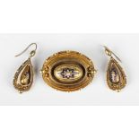 A Victorian gold, half-pearl and blue enamelled oval brooch with applied bead and wirework