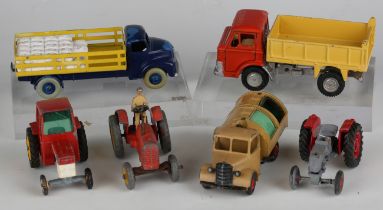 A collection of diecast vehicles and accessories, including a Dinky Toys No. 323 triple gang