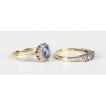A 9ct gold, sapphire and diamond oval cluster ring, claw set with the oval cut sapphire within a