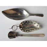 A George III silver caddy spoon, the leaf shaped bowl with engraved decoration, London 1799 by
