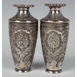 A pair of 20th century Persian white metal posy vases, each of elongated ovoid form with a flared