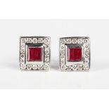 A pair of white gold, ruby and diamond rectangular cluster earstuds, each collet set with two