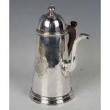 A George II silver coffee pot with domed hinged lid and knop finial above a tapering cylindrical