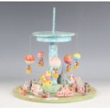 A small group of Yootha Rose painted wooden toys, comprising a circular village diorama with five
