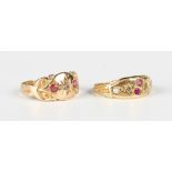 An 18ct gold, red gem and diamond three stone ring with scroll decoration to the shoulders,