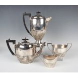 A George V silver four-piece tea set of oval half-reeded form, comprising hot water pot with