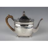 A George III silver cushion shaped teapot, the hinged lid with pineapple finial above bands of