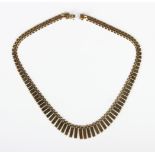 A gold necklace, the front in a graduated bar link design with pairs of beads to the drops, on a