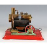 A Mamod SE3 stationary engine, on a red plinth base.Buyer’s Premium 29.4% (including VAT @ 20%) of