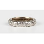 A diamond full eternity ring, mounted with three rows of small circular cut diamonds in a domed