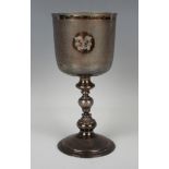 A George V silver goblet, the cylindrical body engraved with opposing crests against a textured