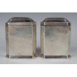 A pair of George I Britannia standard silver canted corner rectangular tea caddies with domed