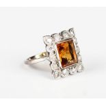 A diamond and citrine rectangular cluster ring, mounted with the rectangular cut citrine within a