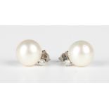 A pair of platinum, diamond and South Sea cultured pearl earrings, each mounted with a large