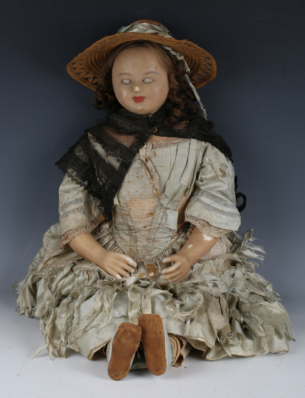 A wax-over-composition doll Louise with brown wig, actuated sleeping brown eyes, painted lips and