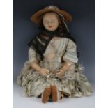 A wax-over-composition doll Louise with brown wig, actuated sleeping brown eyes, painted lips and