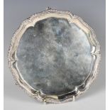 A George III silver circular card salver, the centre engraved with a circular cartouche framed by