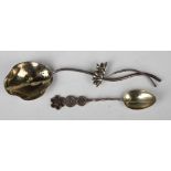 A Chinese silver spoon, the bowl formed as a lotus leaf with entwined stem and lotus flower