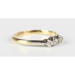 A gold, platinum and diamond three stone ring, mounted with a row of circular cut diamonds, detailed