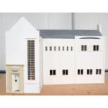 A modern Arts and Crafts style doll's house, the hinged double-front revealing a staircase and