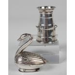 A late Victorian silver novelty pepper caster in the form of a swan with engraved plumage and hinged