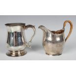 A George III silver baluster christening tankard with foliate capped scroll handle, on a circular