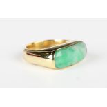 A gold and jade ring in a curved rectangular design, unmarked, weight 8.3g, ring size approx K1/2,