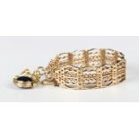 A 9ct gold twisted bar and curved bar link gate bracelet on a 9ct gold heart shaped padlock clasp,