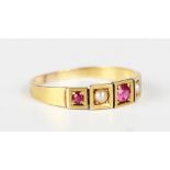 A gold ring, mounted with three cushion cut rubies alternating with two seed pearls in square shaped