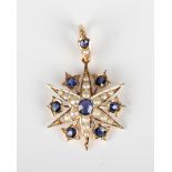 A gold, sapphire and seed pearl pendant, designed as a six pointed starburst, mounted with seven