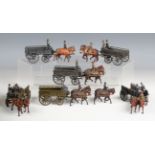 Ten Britains lead army horse-drawn wagons and figures, another wagon and a horse-drawn limber and