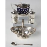 A George V silver boat shaped bonbon basket with reeded swing handle above pierced sides, on an oval