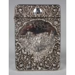 An Edwardian silver castle-top card case of rectangular form with hinged lid, the front embossed