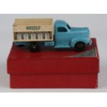 A French Dinky Toys No. 25-0 milk truck with blue cab, cream body and black ridged wheels, with