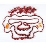 Two single row necklaces of graduated cherry coloured oval reconstituted amber beads, gross weight