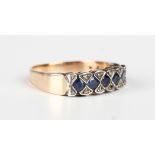 A gold, sapphire and diamond ring, mounted with a row of five circular cut sapphires with four pairs