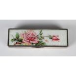 An Edwardian silver and enamelled rectangular box, the hinged lid painted with pink roses against