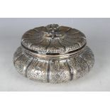 An early 20th century Italian .800 silver circular box and cover of lobed bombé form, embossed and