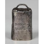 A late Victorian Irish silver novelty desk bell in the form of a cowbell with textured finish, the