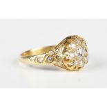 A gold and diamond cluster ring, mounted with the principal cushion cut diamond within a surround of