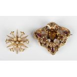 A Victorian gold, citrine, garnet and red gem set brooch in a foliate scroll pierced design, mounted