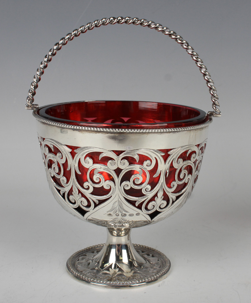 A Victorian silver bonbon basket with spiral swing handle, the circular body pierced and engraved - Image 3 of 3