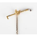 A gold stickpin, the finial designed as a fox's mask and a riding crop, detailed '15ct', weight 1.